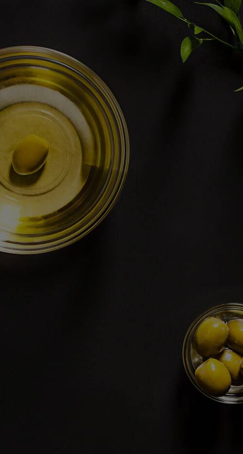 olive-oil-and-olive-branch-on-the-wooden-table-full